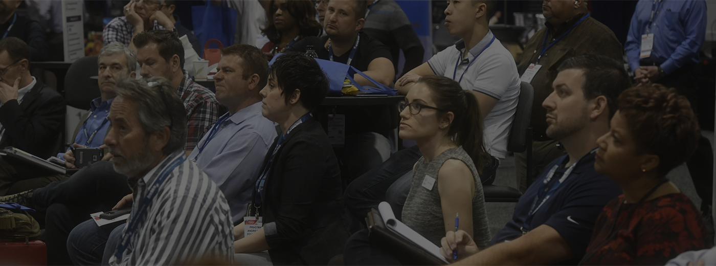 Attendees listening to a conference presentation