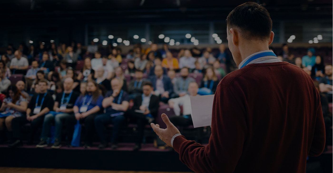 Men listening attentively to conference presentation 