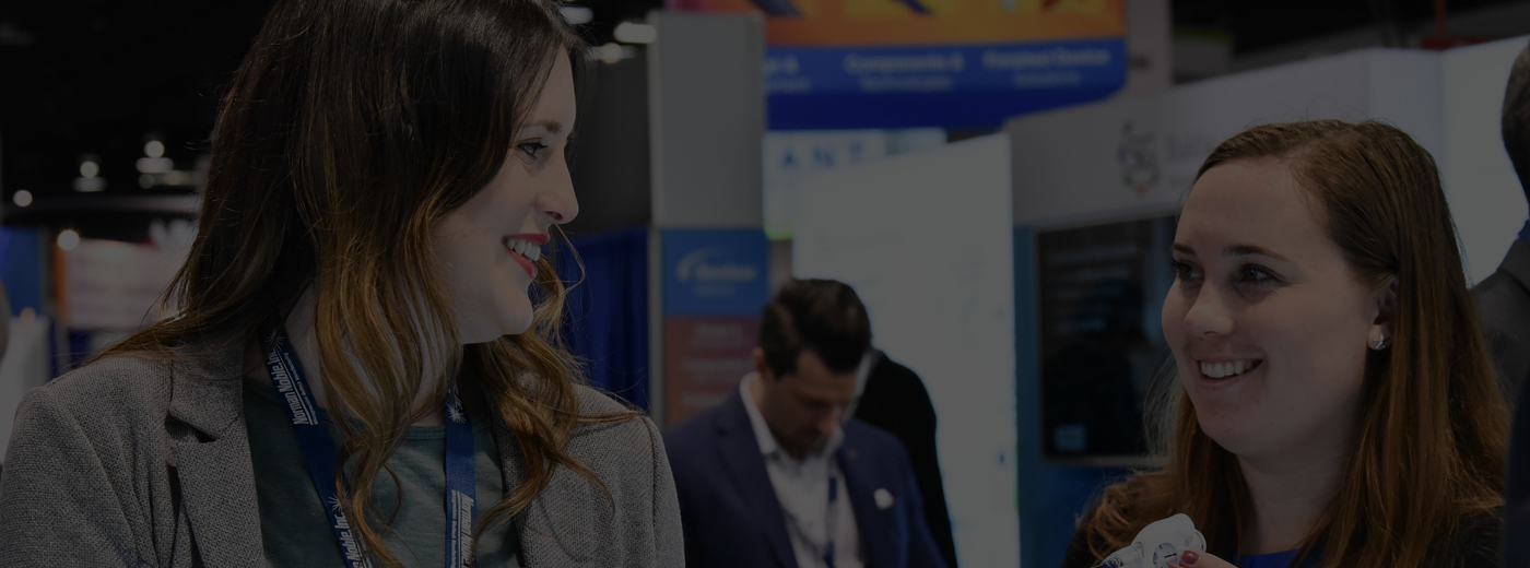 Two women having a conversation in the expo hall