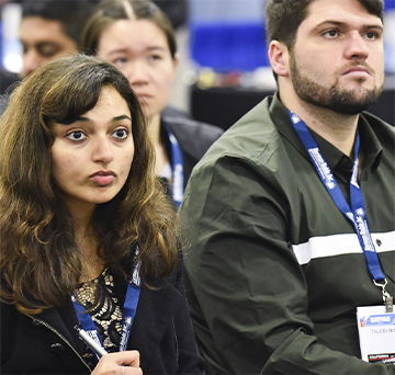 Attendees listening to a conference presentation