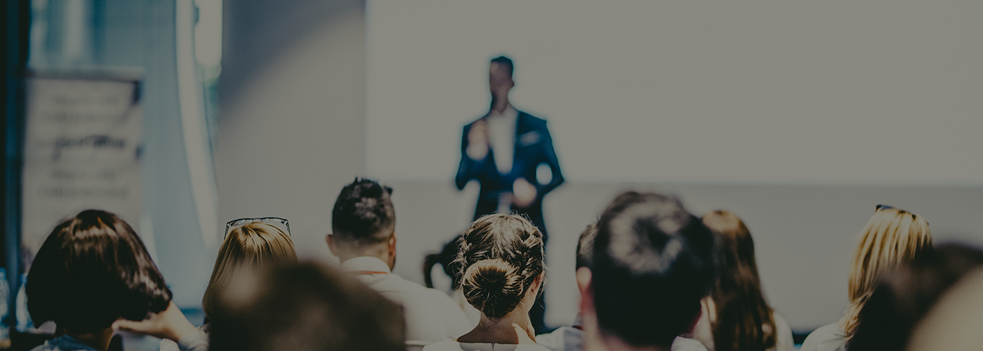 Male business speaker giving a talk at business conference event