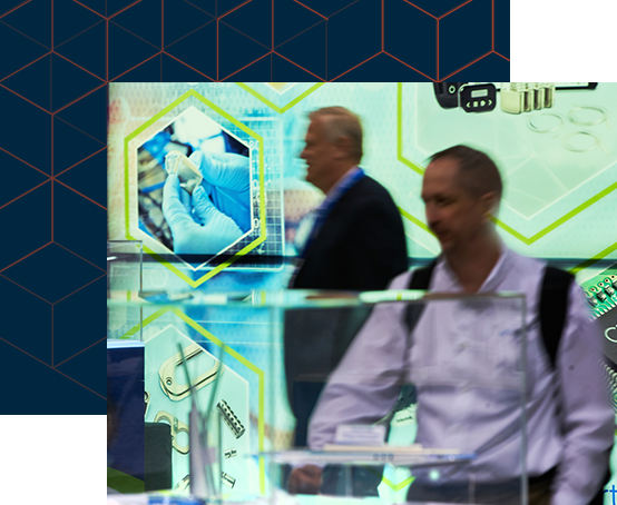 Two attendees examining products in the expo hall floor